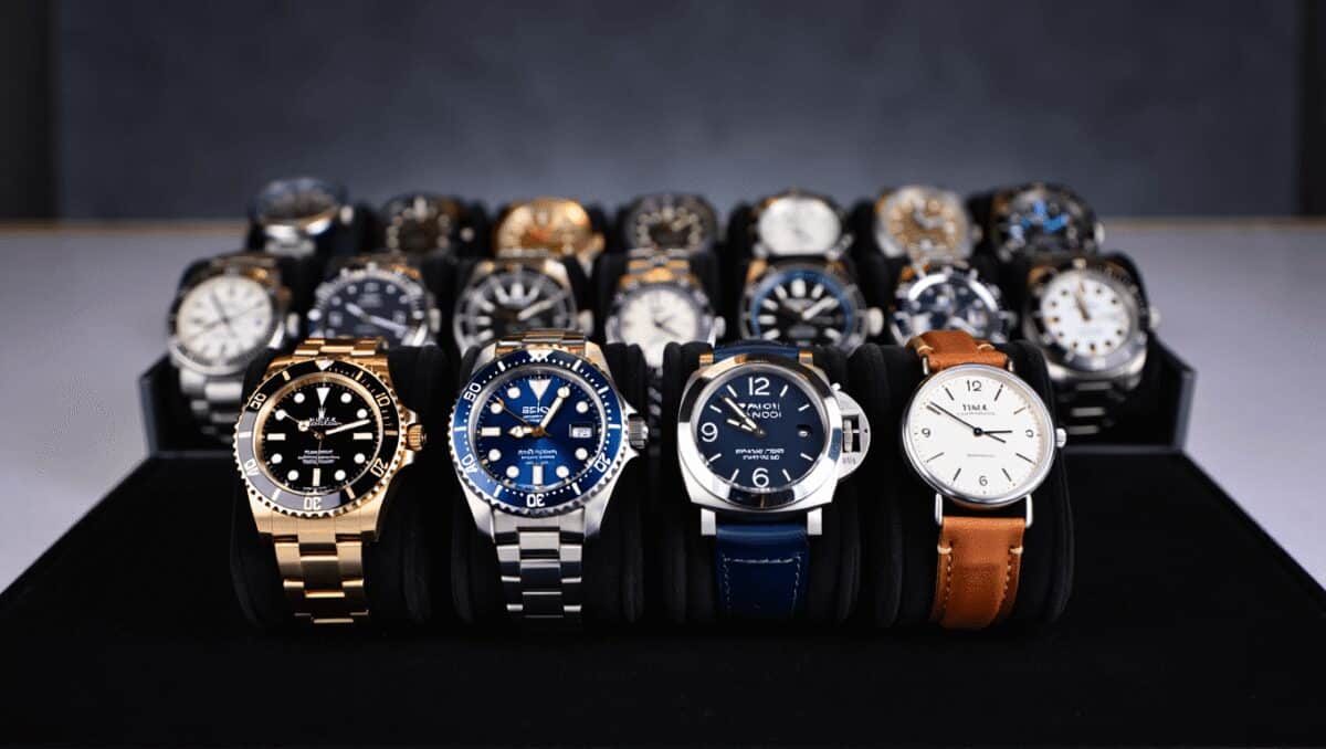 Silver Grand Seiko wristwatch with textured light blue dial and stainless steel bracelet on icy surface.