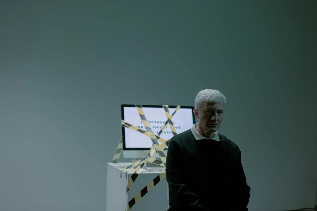 Computer screen showing a 404 error message with a frustrated user silhouette in the background