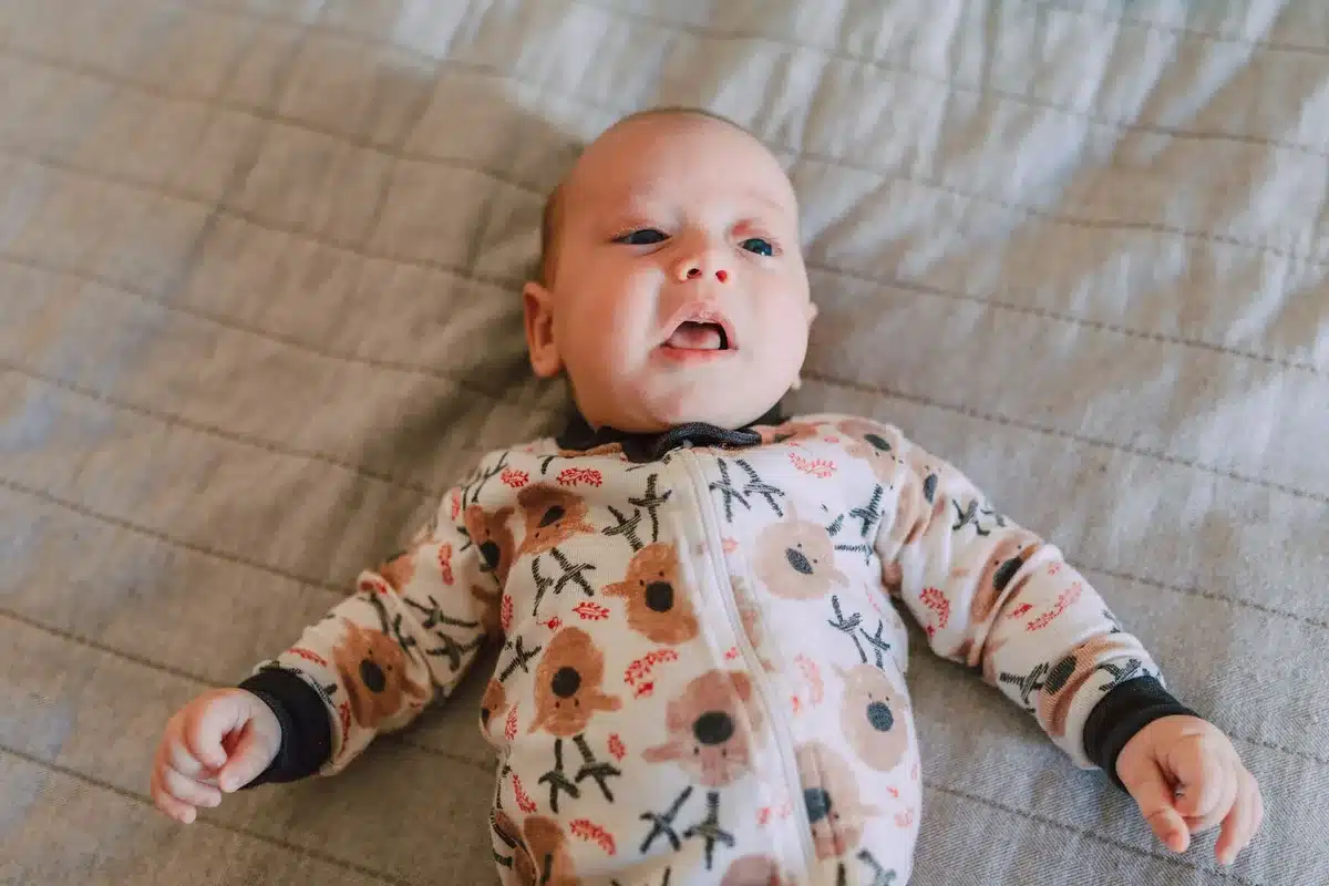 Soft baby onesies and two-way zip sleepers in playful prints