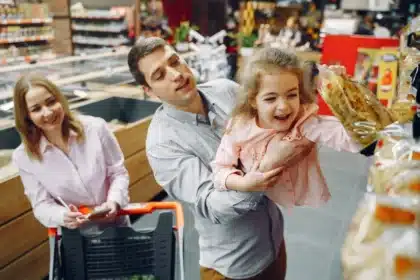 Parent and child browsing children's clothing in a retail store during back-to-school season