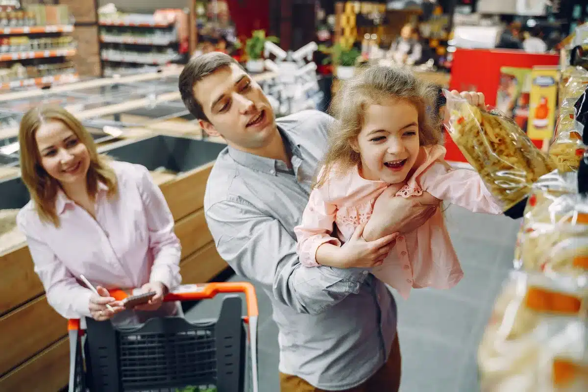 Parent and child browsing children's clothing in a retail store during back-to-school season