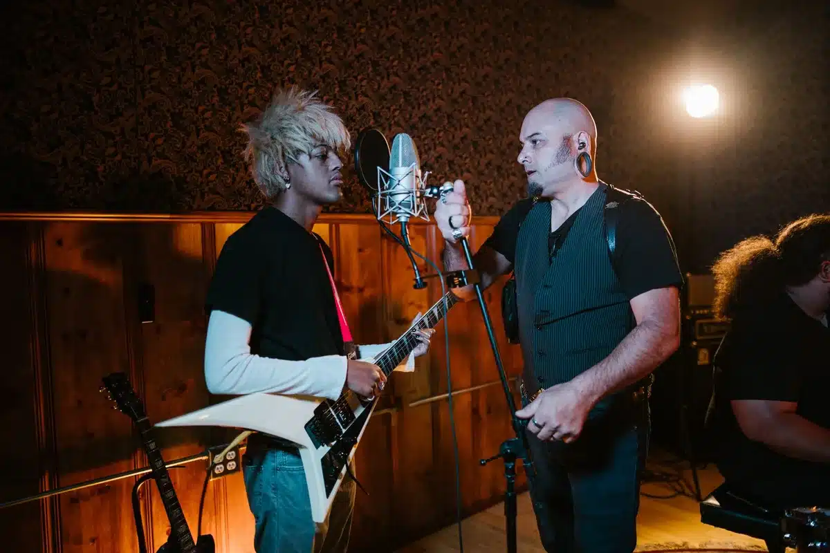 Session musicians recording in a professional studio with instruments and microphones