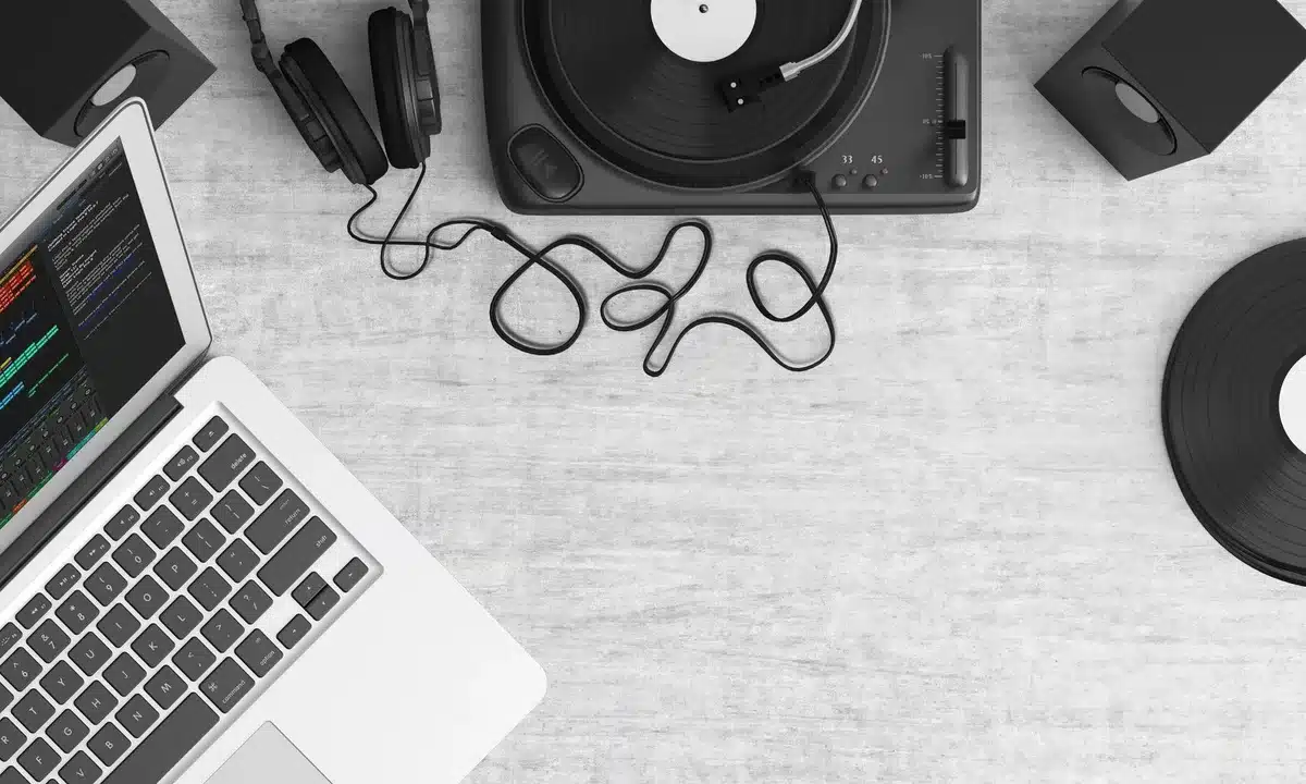Vinyl record playing in a dimly lit recording studio with vintage tape reels and analog equipment