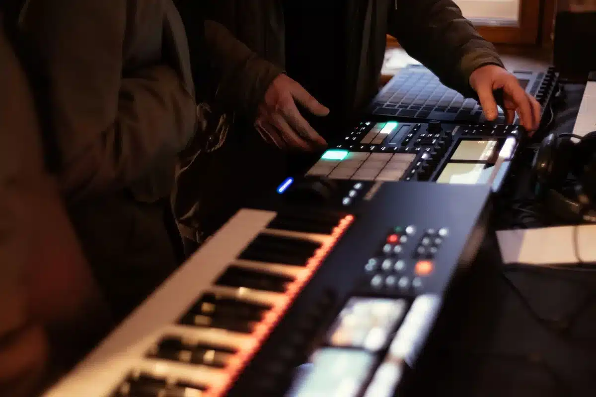 Musicians and producers in a 1980s-style recording studio with synthesizers and mixing equipment