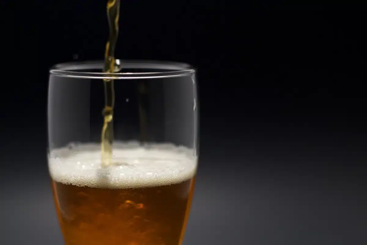 Frothy non-alcoholic beer poured into a glass, showcasing rich color and head