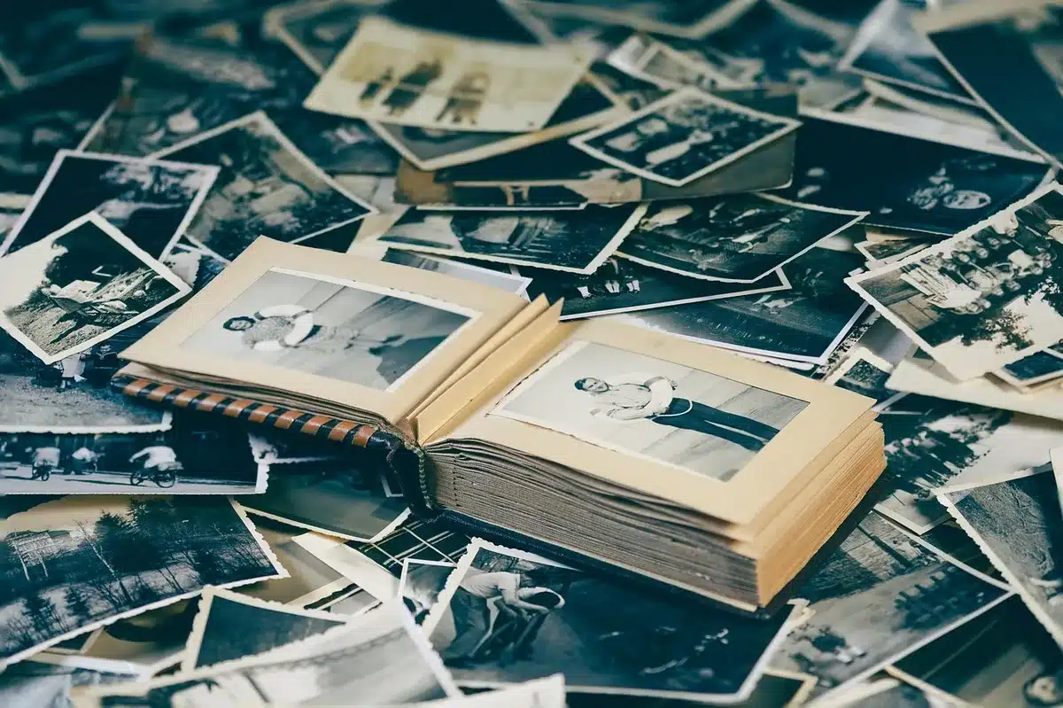 A table with framed family photos and a small birthday card