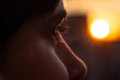 Anonymized silhouettes near a gas station at dusk, conveying a guarded public moment