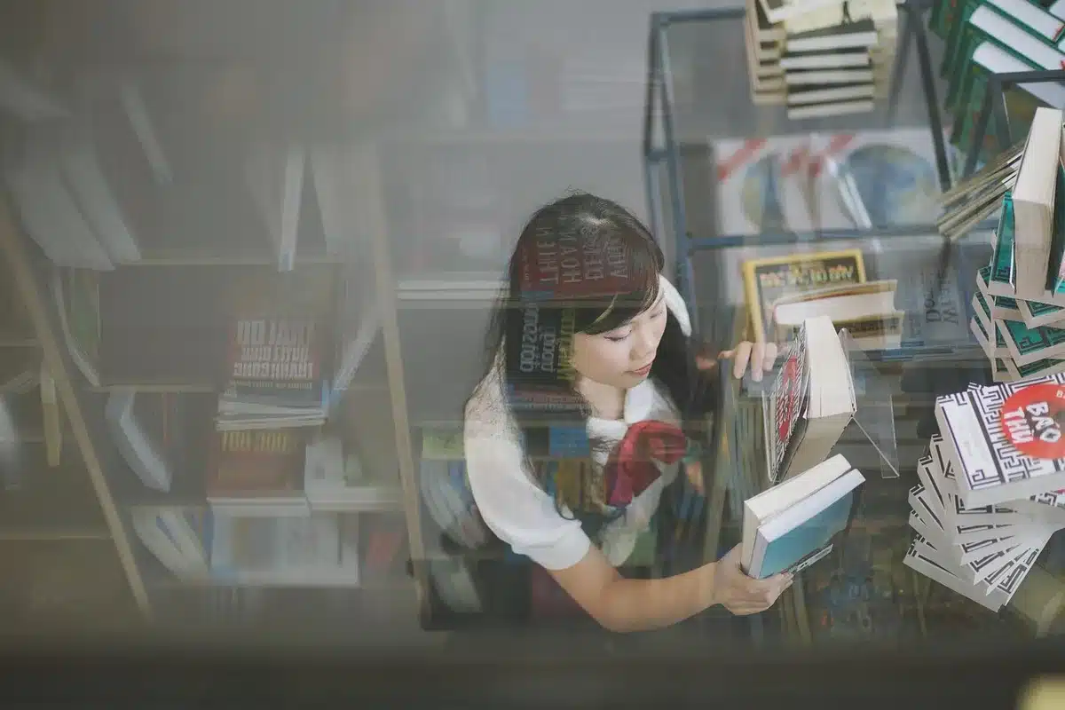 A student recording music on a smartphone in a library