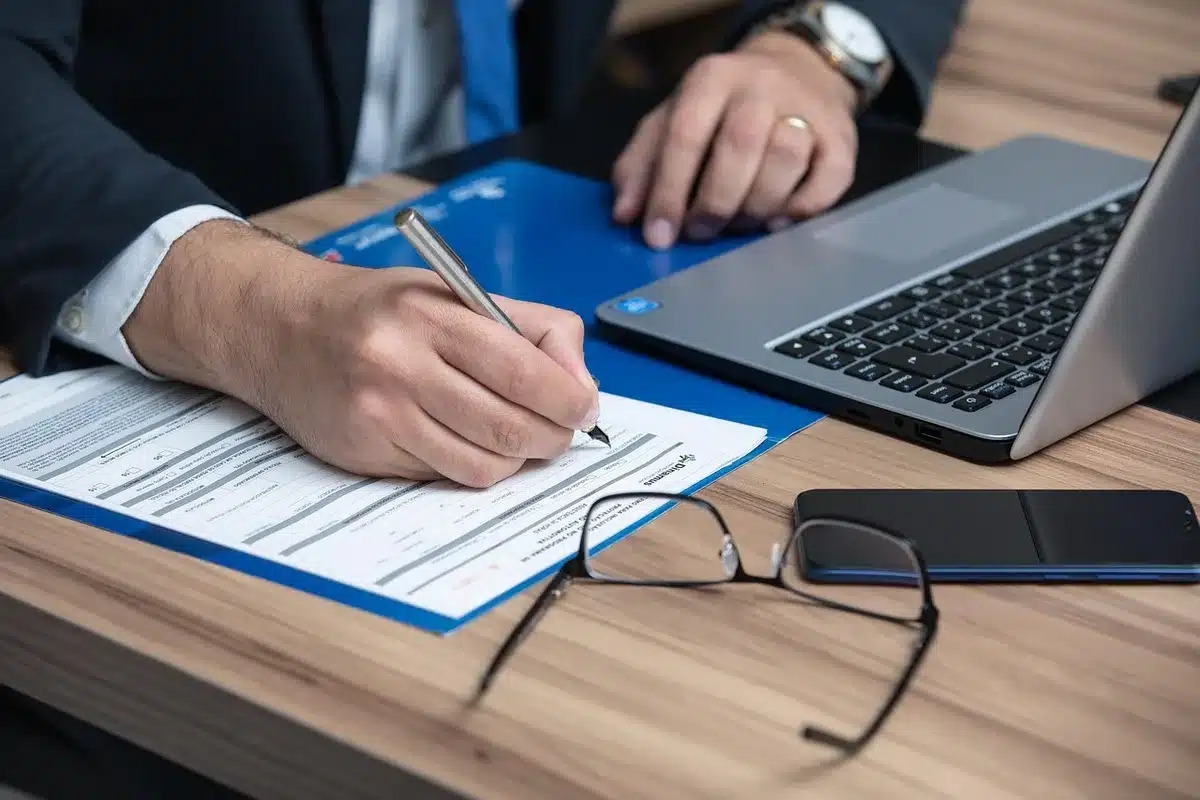 Stack of trust documents and envelopes on a table in an office