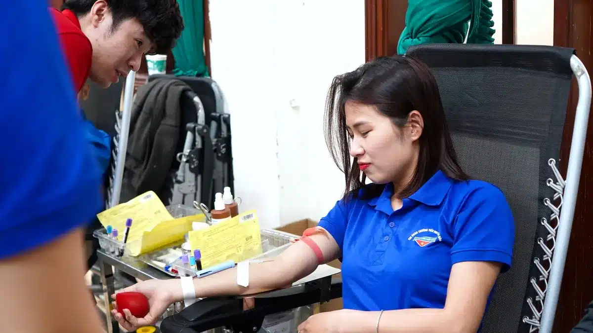 Volunteer meeting a family of a sick child in a hospital corridor