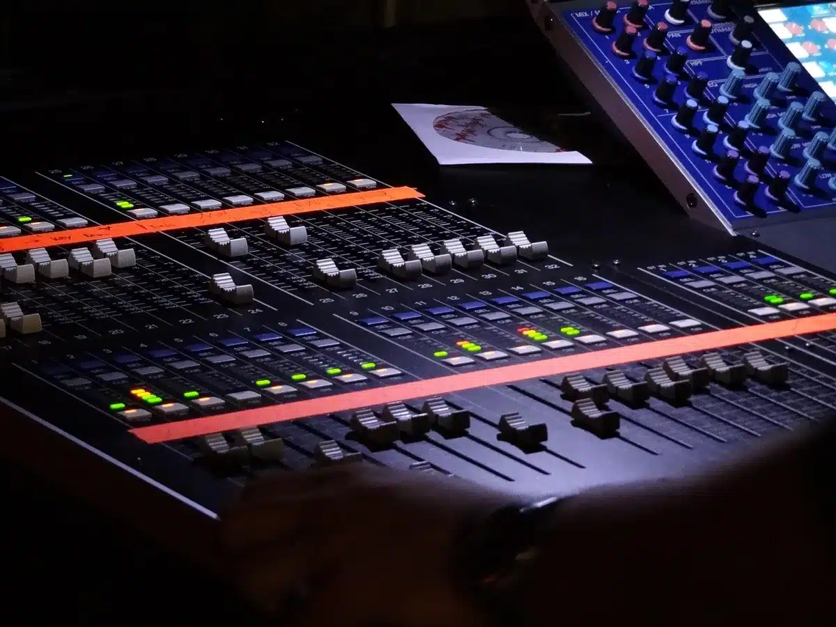 Mixing console and studio monitors during audio mastering