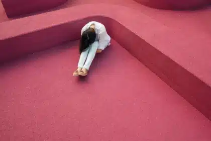 Silhouette of a person in a sheer floral gown on a red-carpet walkway