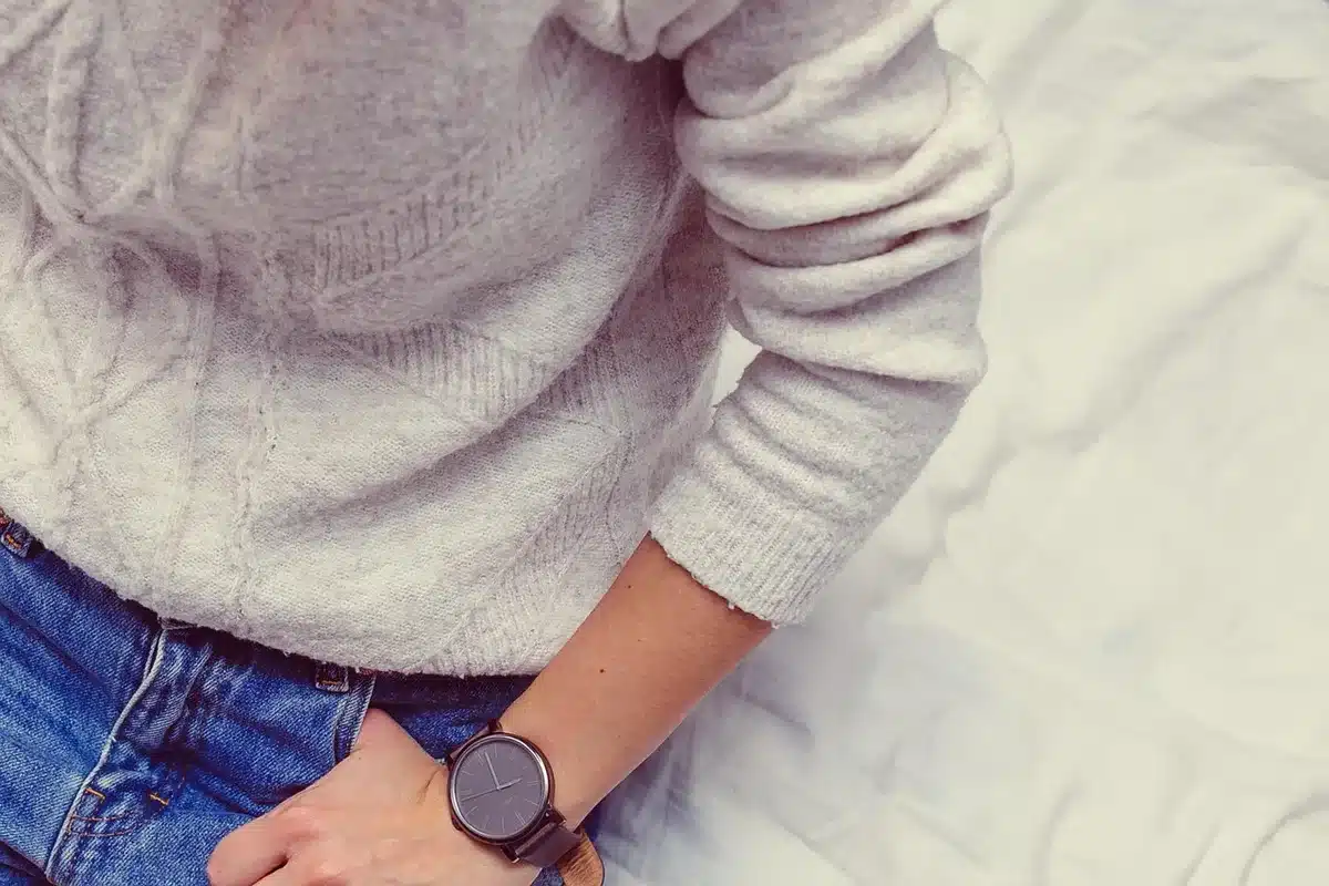 Crisp white tee, blazer and dark jeans laid out to show styling
