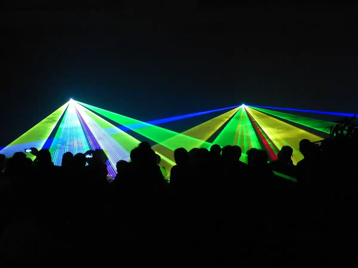 Choreographed drones forming patterns above a stadium at night