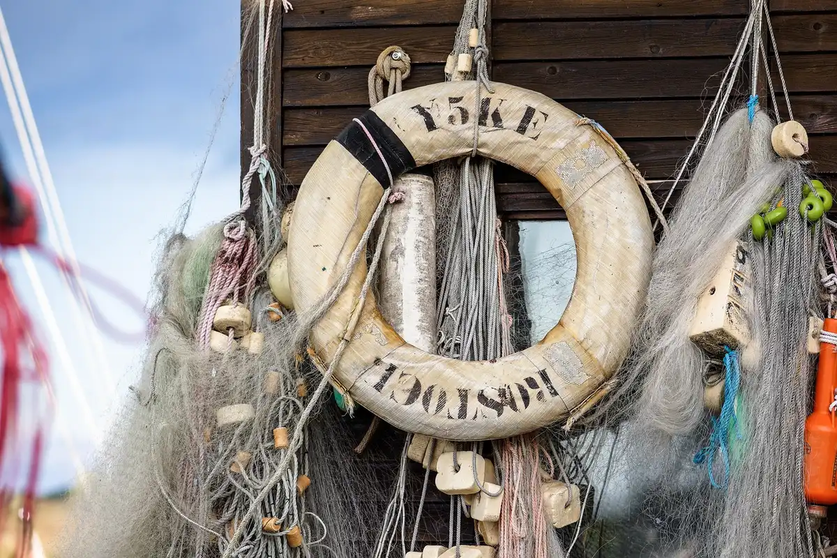 Small fishing vessel at sea near Norway shore, suggesting responsible sourcing