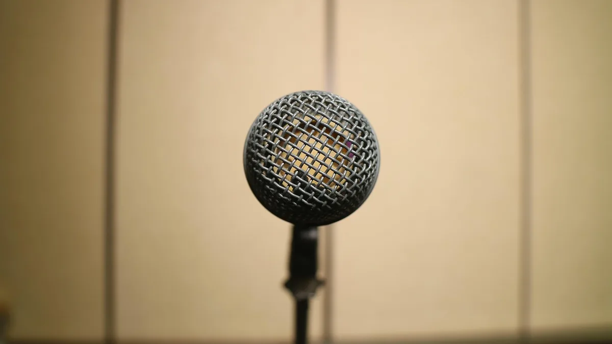 Empty TV news desk and studio lights suggesting a live broadcast moment