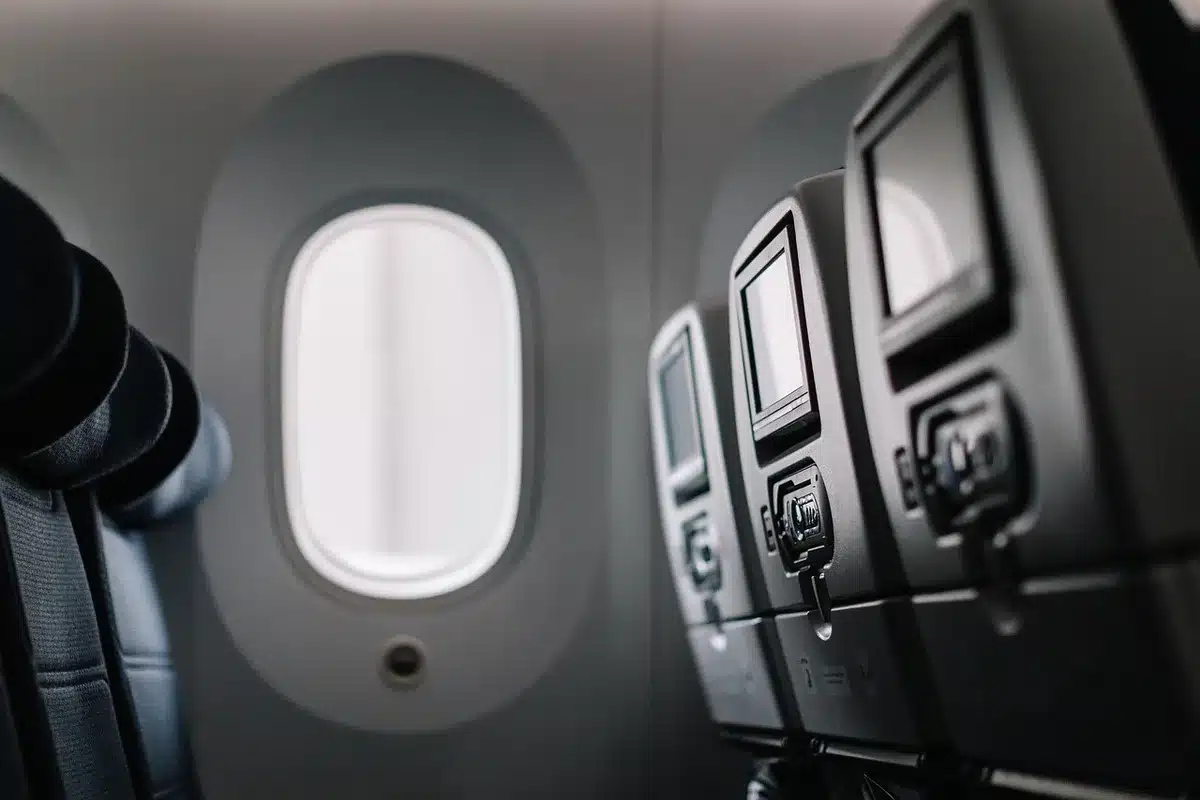 Airplane interior with passengers looking toward the front during an incident