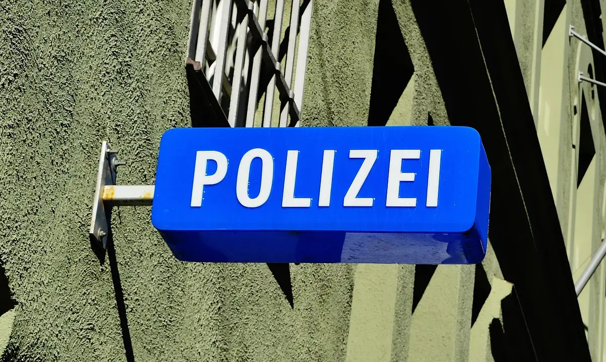 Official envelope and police paperwork on a desk related to a complaint
