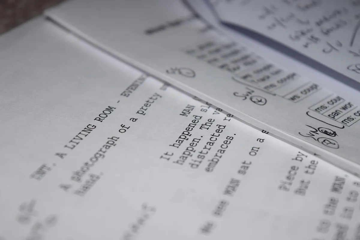 Close-up of printed manuscript pages and a pen